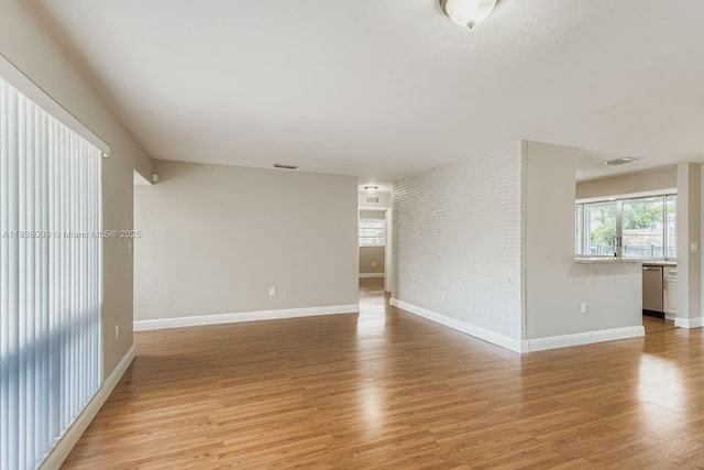 7904 Alhambra Blvd, Miramar, FL 33023 - spare room featuring light wood-style floors and brick wall