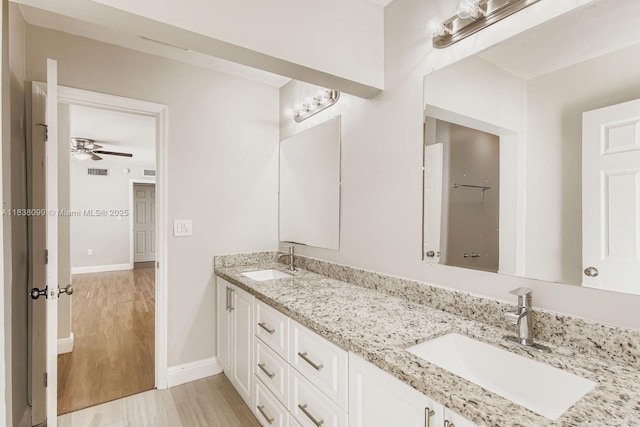 7904 Alhambra Blvd, Miramar, FL 33023 - bathroom with double vanity, wood finished floors, and ceiling fan