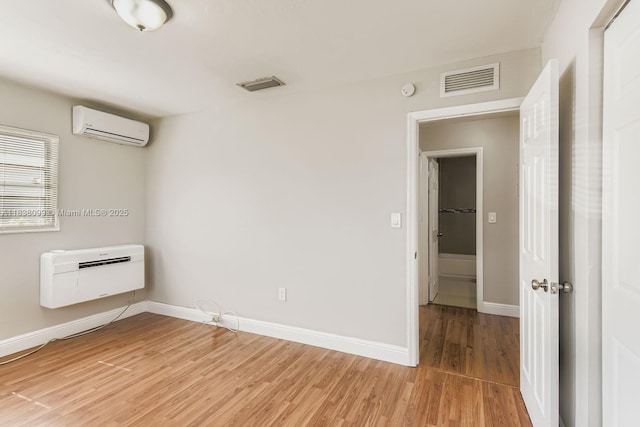7904 Alhambra Blvd, Miramar, FL 33023 - spare room featuring a wall unit AC and light wood-type flooring