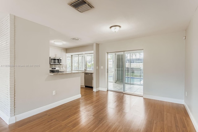 7904 Alhambra Blvd, Miramar, FL 33023 - spare room with wood finished floors and healthy amount of natural light