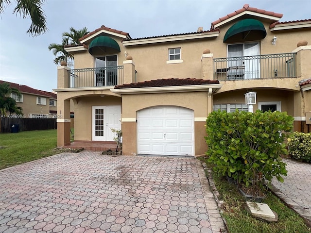 6865 SW 158th Pl, Miami, FL 33193 - mediterranean / spanish-style house with a balcony, stucco siding, an attached garage, decorative driveway, and a tiled roof