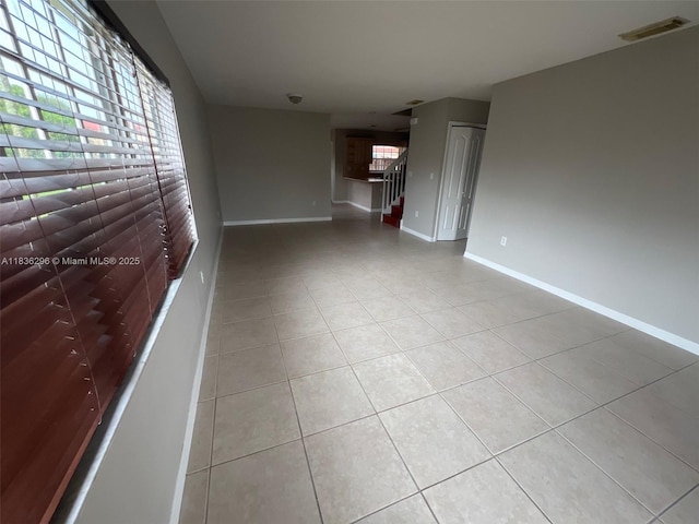 6865 SW 158th Pl, Miami, FL 33193 - unfurnished living room with light tile patterned floors and stairway