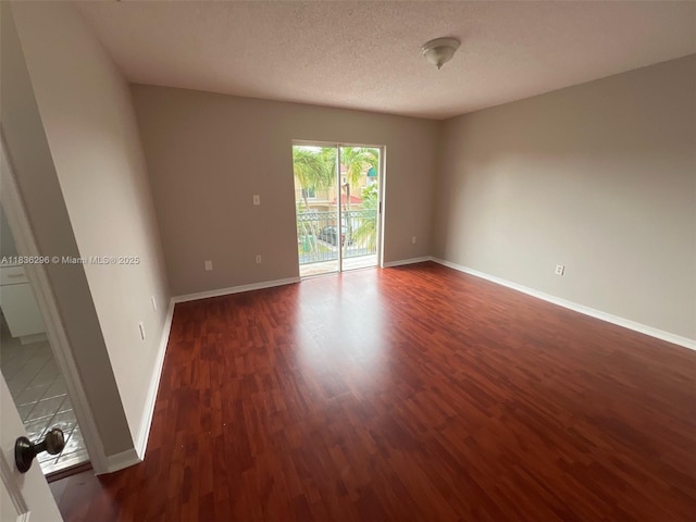 6865 SW 158th Pl, Miami, FL 33193 - empty room with wood finished floors and a textured ceiling
