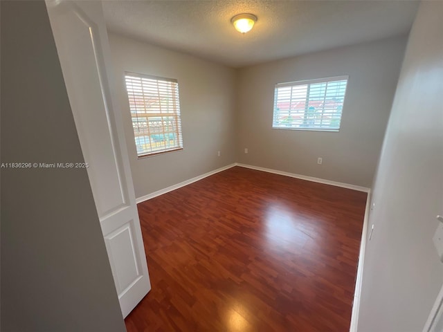 6865 SW 158th Pl, Miami, FL 33193 - empty room with dark wood-style flooring and baseboards