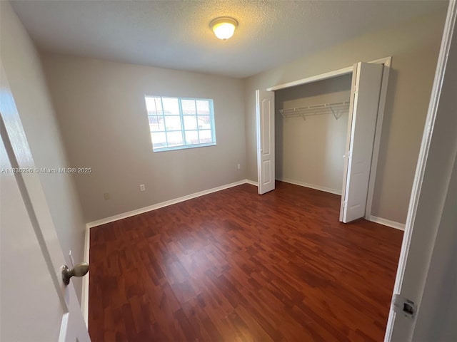 6865 SW 158th Pl, Miami, FL 33193 - unfurnished bedroom with dark wood finished floors, a closet, and a textured ceiling