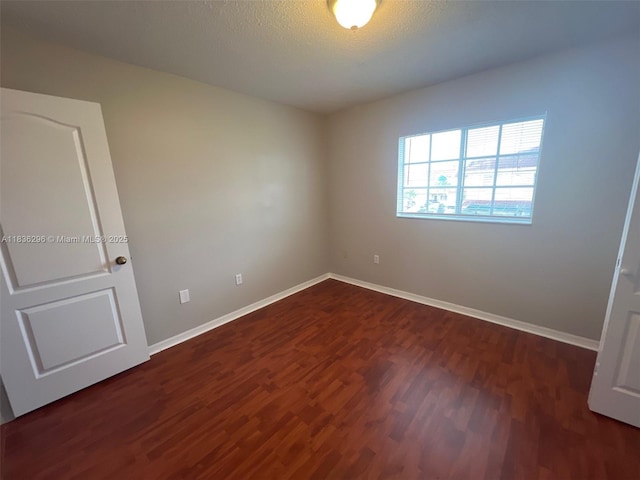 6865 SW 158th Pl, Miami, FL 33193 - spare room with dark wood-style flooring and a textured ceiling