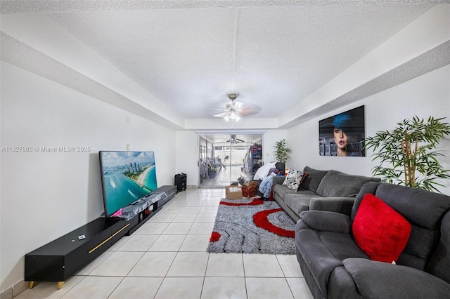1178 NW 123rd Pl Unit 1210, Miami, FL 33182 - living area featuring a textured ceiling, light tile patterned floors, a ceiling fan, and a tray ceiling