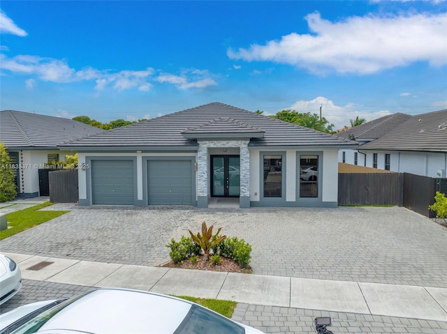 14832 SW 39th Ter, Miami, FL 33185 - view of front of home with french doors, a garage, a tiled roof, and stucco siding