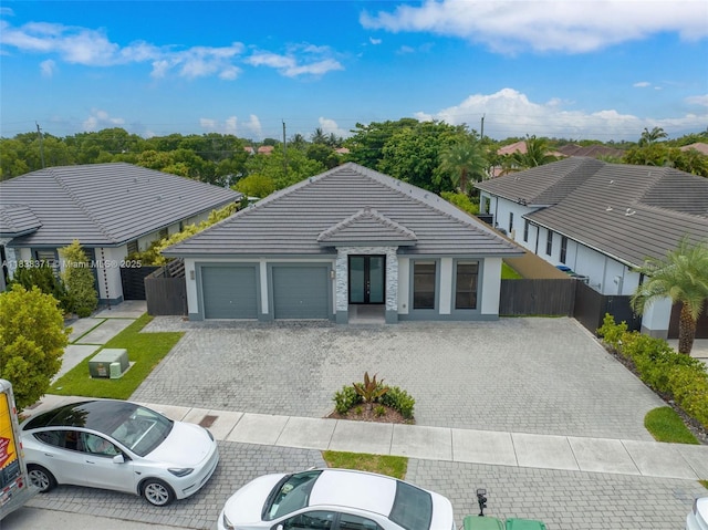 14832 SW 39th Ter, Miami, FL 33185 - ranch-style home with an attached garage, a tiled roof, decorative driveway, stone siding, and stucco siding