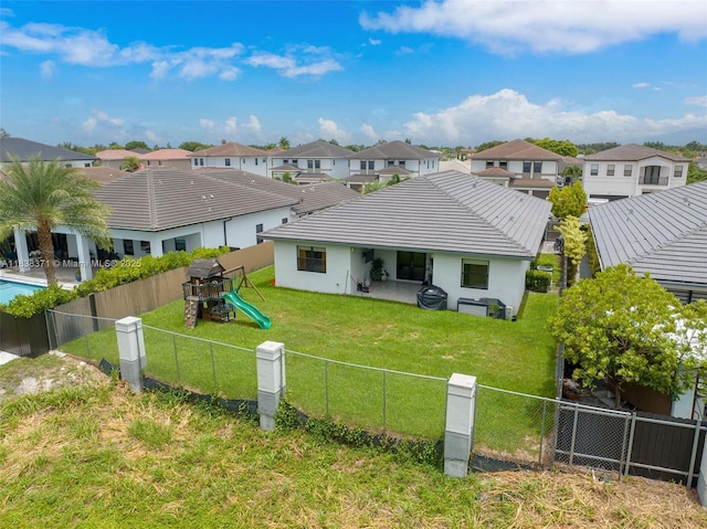 14832 SW 39th Ter, Miami, FL 33185 - rear view of house with a fenced backyard, a residential view, a patio area, and a tiled roof