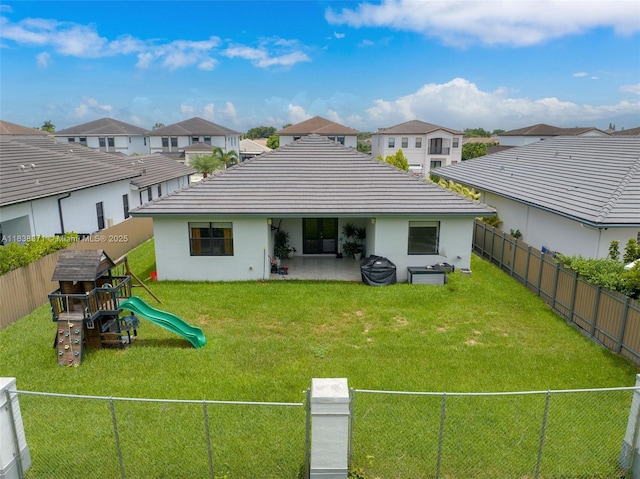 14832 SW 39th Ter, Miami, FL 33185 - rear view of property featuring a fenced backyard, a playground, a residential view, and stucco siding
