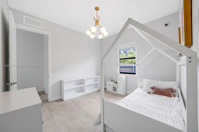14832 SW 39th Ter, Miami, FL 33185 - bedroom with a chandelier, vaulted ceiling, and concrete floors