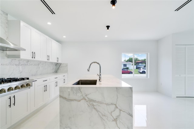 9800 SW 159th St, Miami, FL 33157 - kitchen with stainless steel gas stovetop, decorative backsplash, light stone counters, white cabinets, and recessed lighting