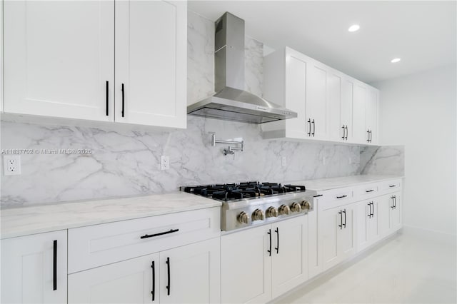 9800 SW 159th St, Miami, FL 33157 - kitchen featuring wall chimney range hood, stainless steel gas cooktop, light stone countertops, white cabinetry, and backsplash