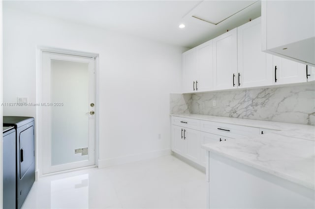 9800 SW 159th St, Miami, FL 33157 - kitchen featuring separate washer and dryer, light stone counters, decorative backsplash, white cabinets, and recessed lighting