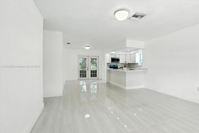 6424 Pierce St, Hollywood, FL 33024 - unfurnished living room with french doors and plenty of natural light