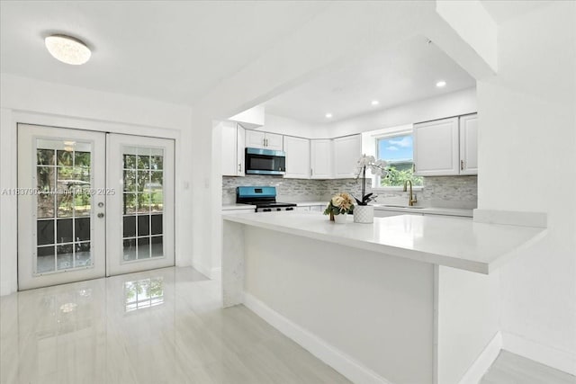 6424 Pierce St, Hollywood, FL 33024 - kitchen featuring stainless steel appliances, backsplash, light countertops, and french doors