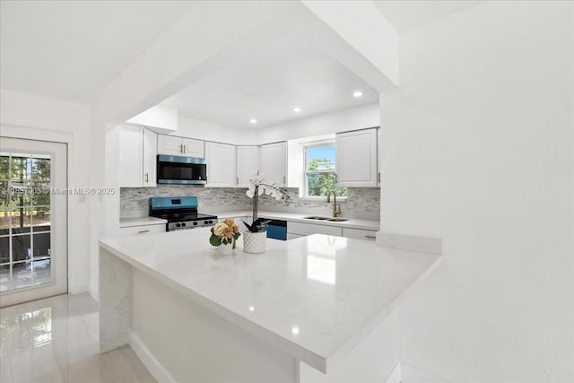 6424 Pierce St, Hollywood, FL 33024 - kitchen featuring stainless steel appliances, decorative backsplash, white cabinets, and recessed lighting