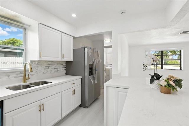6424 Pierce St, Hollywood, FL 33024 - kitchen featuring stainless steel refrigerator with ice dispenser, plenty of natural light, tasteful backsplash, light countertops, and recessed lighting