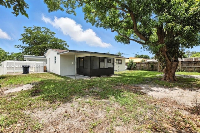 6424 Pierce St, Hollywood, FL 33024 - back of house with a sunroom, a fenced backyard, and stucco siding