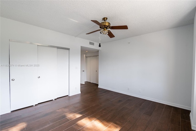 10140 W Bay Harbor Dr Unit 201A, Bay Harbor Islands, FL 33154 - unfurnished bedroom featuring a closet, dark wood-style flooring, a textured ceiling, and a ceiling fan