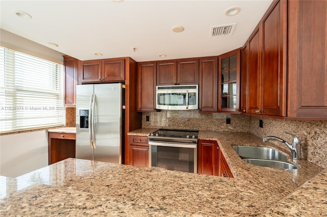 10140 W Bay Harbor Dr Unit 201A, Bay Harbor Islands, FL 33154 - kitchen with appliances with stainless steel finishes, light stone countertops, decorative backsplash, glass insert cabinets, and recessed lighting