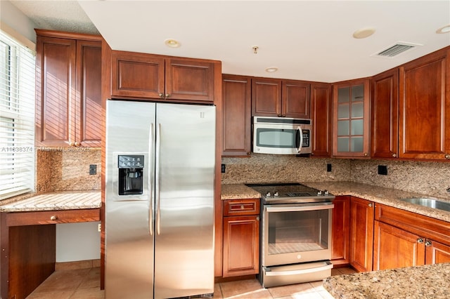 10140 W Bay Harbor Dr Unit 201A, Bay Harbor Islands, FL 33154 - kitchen with appliances with stainless steel finishes, light stone countertops, light tile patterned flooring, and recessed lighting