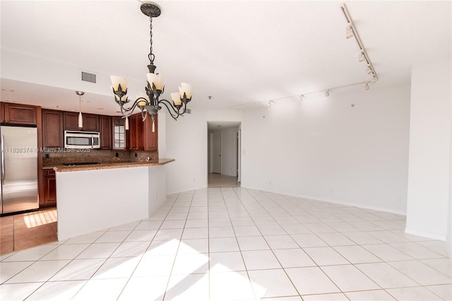 10140 W Bay Harbor Dr Unit 201A, Bay Harbor Islands, FL 33154 - kitchen featuring stainless steel appliances, track lighting, open floor plan, a chandelier, and decorative backsplash