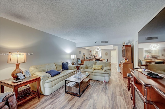23344 Carolwood Ln Unit 303, Boca Raton, FL 33428 - living area featuring a textured ceiling and light wood-type flooring