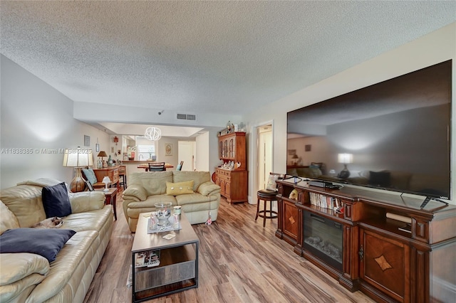 23344 Carolwood Ln Unit 303, Boca Raton, FL 33428 - living room featuring a textured ceiling and light wood-style floors
