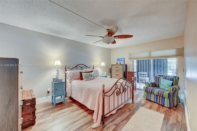 23344 Carolwood Ln Unit 303, Boca Raton, FL 33428 - bedroom featuring wood finished floors, a textured ceiling, and a ceiling fan