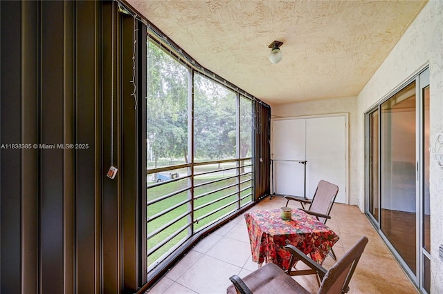 23344 Carolwood Ln Unit 303, Boca Raton, FL 33428 - sunroom with a textured ceiling and tile patterned floors