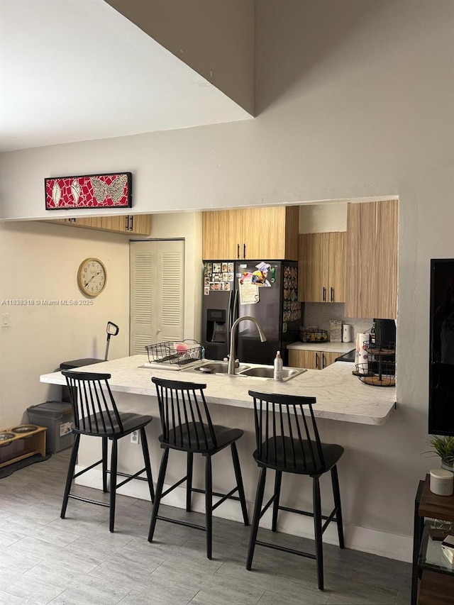575 W Park Dr Unit 202, Miami, FL 33172 - kitchen with stainless steel fridge, a kitchen bar, a peninsula, and a towering ceiling