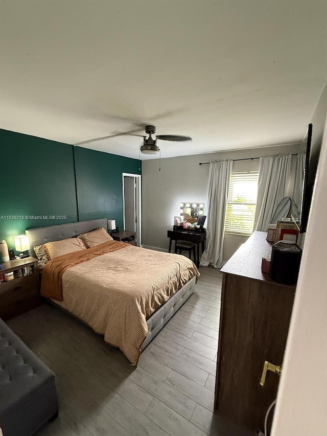 575 W Park Dr Unit 202, Miami, FL 33172 - bedroom with light wood-style flooring and a ceiling fan