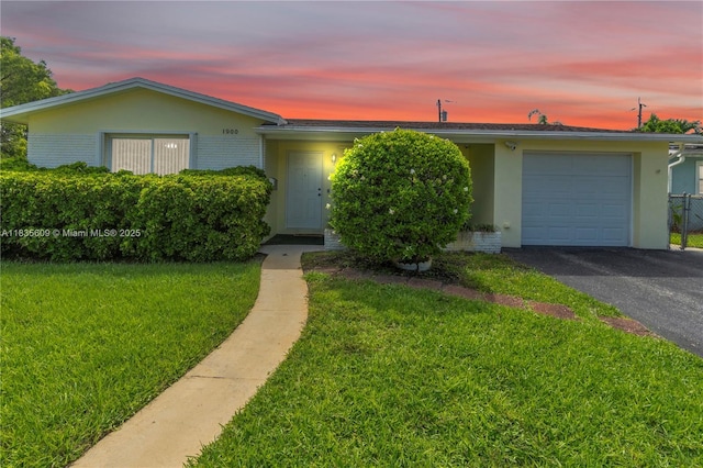 1900 N 31st Ave, Hollywood, FL 33021 - single story home featuring an attached garage, a yard, stucco siding, driveway, and brick siding