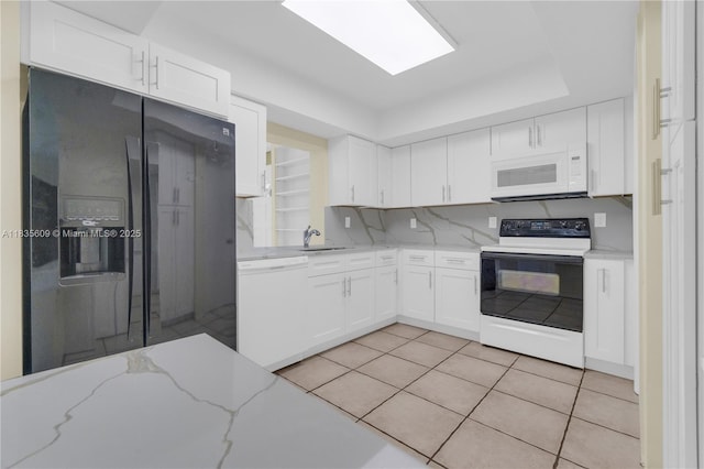 1900 N 31st Ave, Hollywood, FL 33021 - kitchen featuring white appliances, white cabinetry, light tile patterned floors, light stone counters, and decorative backsplash