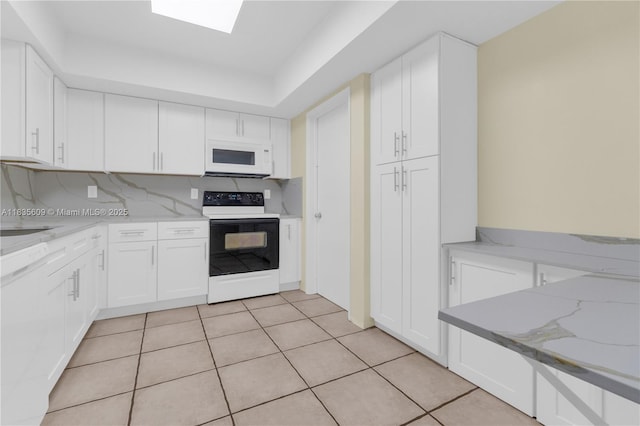 1900 N 31st Ave, Hollywood, FL 33021 - kitchen with white appliances, white cabinets, light stone countertops, and light tile patterned floors