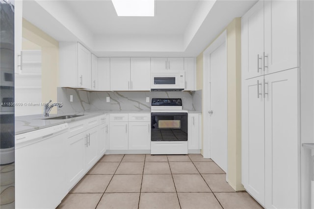 1900 N 31st Ave, Hollywood, FL 33021 - kitchen with white appliances, white cabinetry, light tile patterned floors, light stone countertops, and backsplash