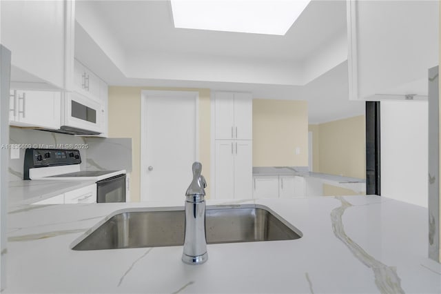 1900 N 31st Ave, Hollywood, FL 33021 - kitchen featuring electric range oven, white microwave, white cabinetry, and a tray ceiling