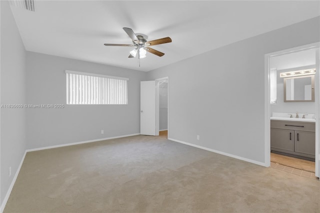 1900 N 31st Ave, Hollywood, FL 33021 - unfurnished bedroom featuring light carpet, a walk in closet, ensuite bathroom, and a ceiling fan
