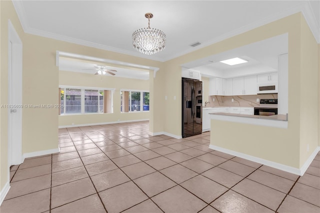 1900 N 31st Ave, Hollywood, FL 33021 - kitchen featuring black fridge with ice dispenser, white microwave, range with electric cooktop, light tile patterned floors, and light countertops