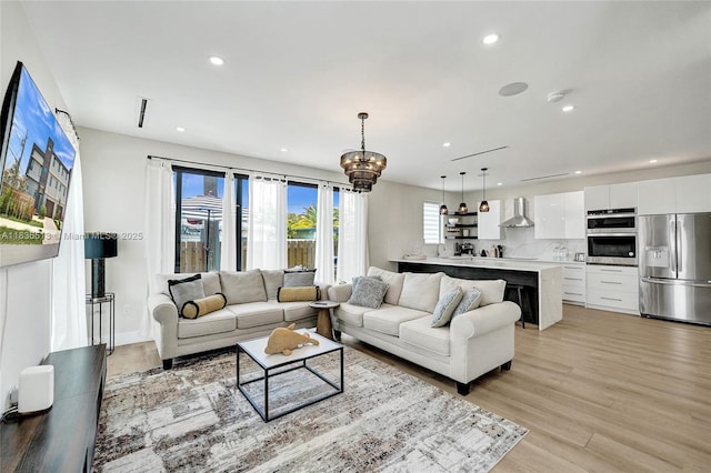 1617 NE 11th St Unit 1, Fort Lauderdale, FL 33304 - living room with recessed lighting, light wood-style flooring, and a chandelier