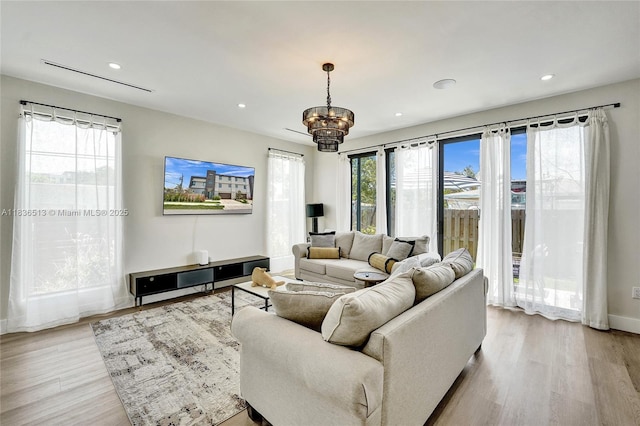 1617 NE 11th St Unit 1, Fort Lauderdale, FL 33304 - living area featuring light wood-style floors, a chandelier, and recessed lighting