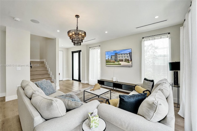 1617 NE 11th St Unit 1, Fort Lauderdale, FL 33304 - living room featuring recessed lighting, light wood-style floors, stairway, and a chandelier