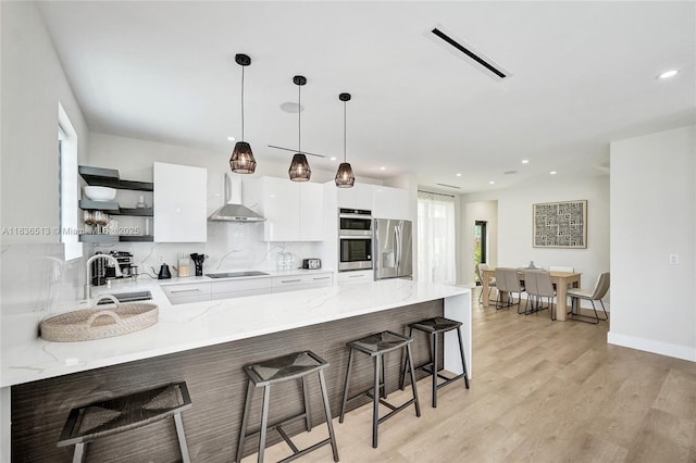 1617 NE 11th St Unit 1, Fort Lauderdale, FL 33304 - kitchen featuring appliances with stainless steel finishes, open shelves, a peninsula, modern cabinets, and white cabinets