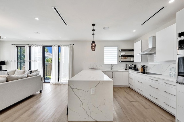 1617 NE 11th St Unit 1, Fort Lauderdale, FL 33304 - kitchen featuring wall chimney exhaust hood, modern cabinets, open shelves, black electric stovetop, and light wood-style flooring