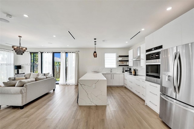 1617 NE 11th St Unit 1, Fort Lauderdale, FL 33304 - kitchen with appliances with stainless steel finishes, modern cabinets, light wood-type flooring, pendant lighting, and open shelves