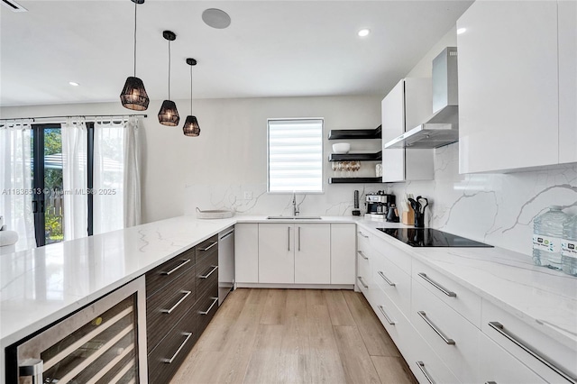 1617 NE 11th St Unit 1, Fort Lauderdale, FL 33304 - kitchen featuring black electric cooktop, beverage cooler, wall chimney exhaust hood, light wood-type flooring, and white cabinets