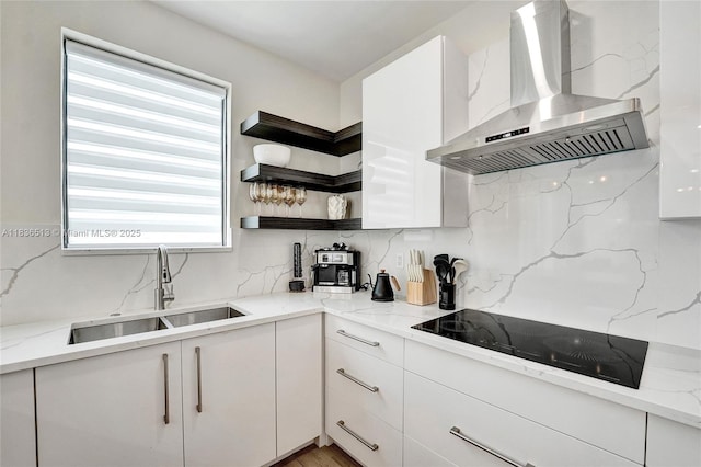 1617 NE 11th St Unit 1, Fort Lauderdale, FL 33304 - kitchen with wall chimney exhaust hood, black electric cooktop, backsplash, and white cabinetry