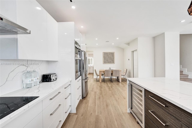 1617 NE 11th St Unit 1, Fort Lauderdale, FL 33304 - kitchen featuring beverage cooler, modern cabinets, white cabinetry, wall chimney exhaust hood, and recessed lighting